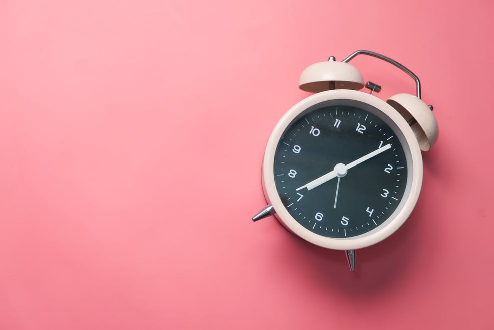 Old Alarm Clock on Pink Background.